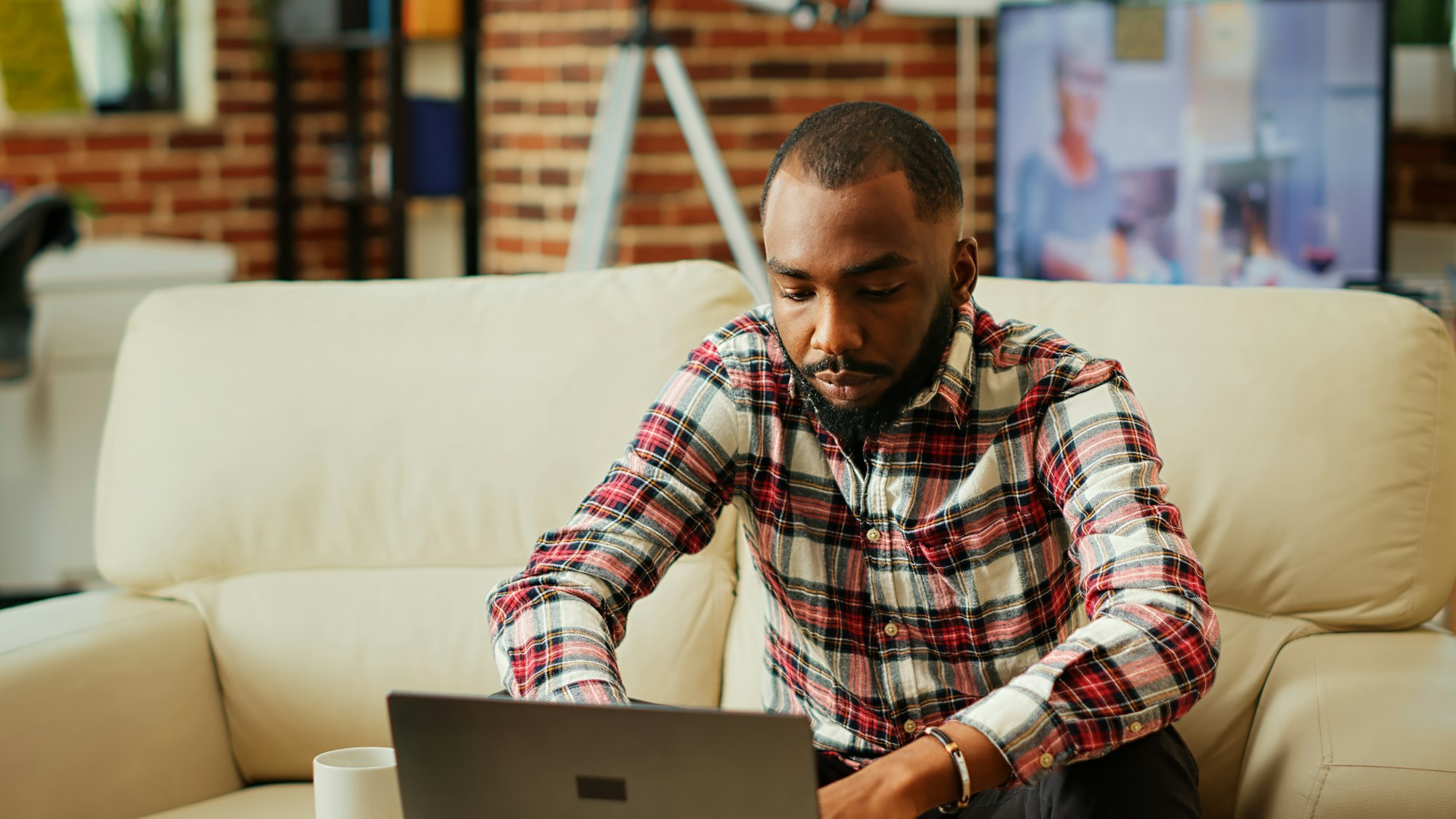 Teleworker inputing data on laptop